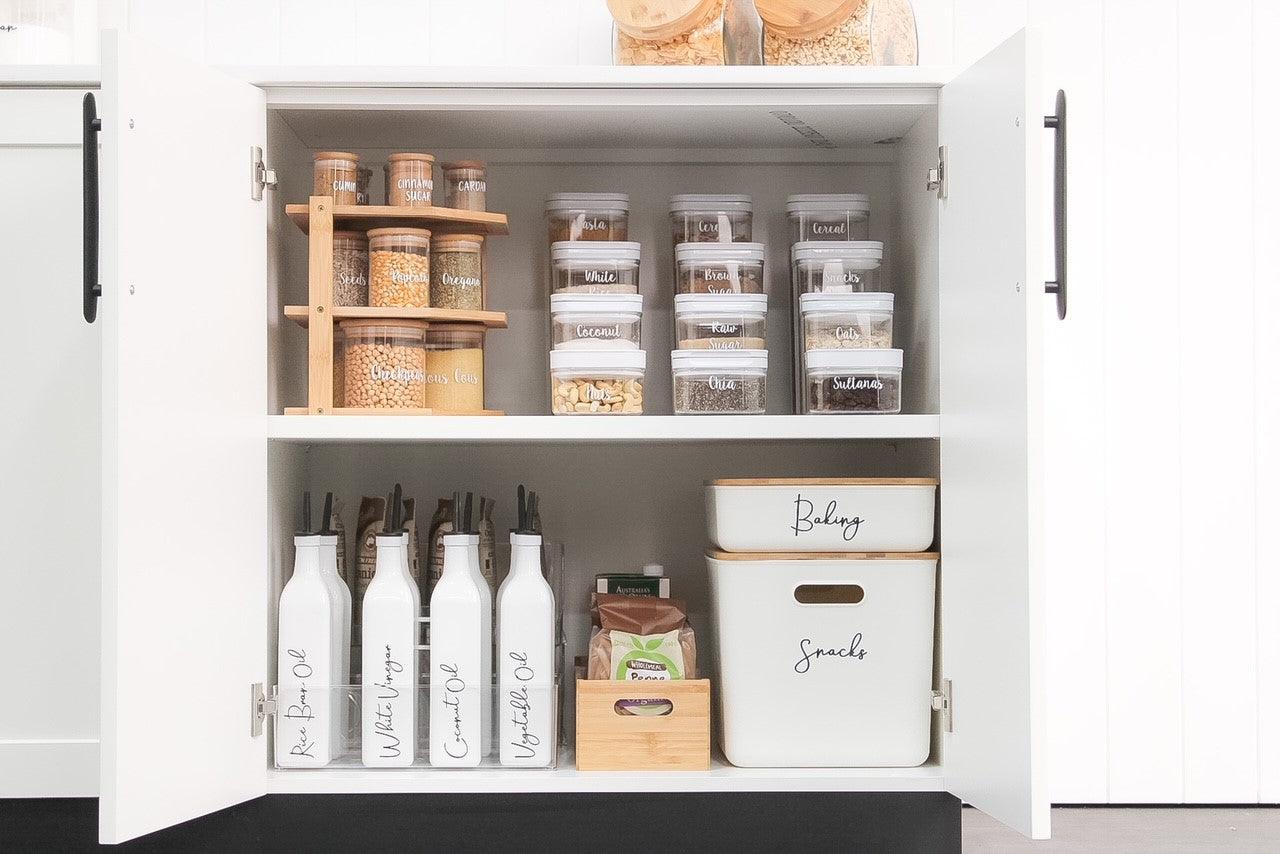 Neatly arranged Flip Canisters storing pantry essentials like nuts, grains, and seeds.