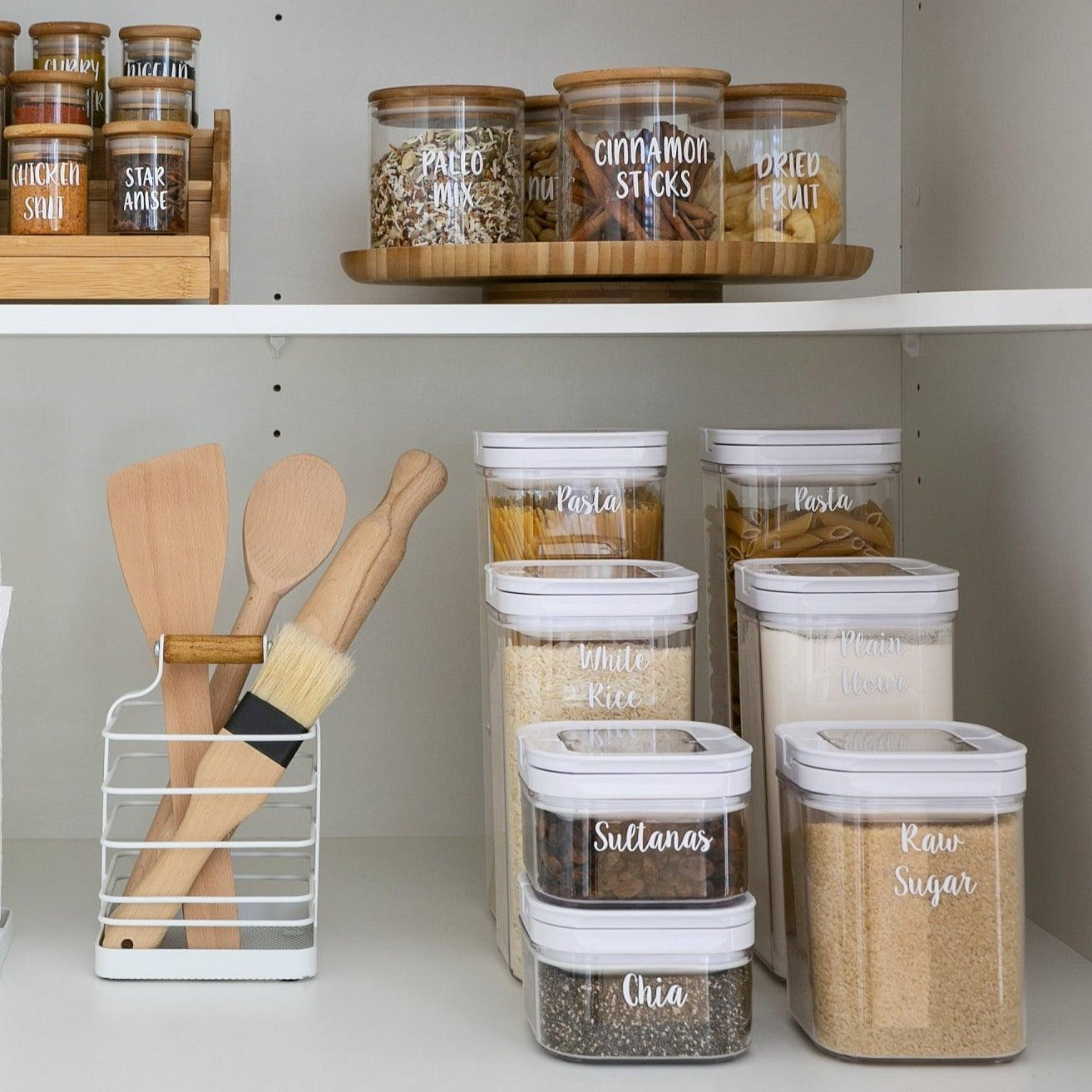 Organised pantry with White Flip Canisters holding pasta, rice, and other essentials.